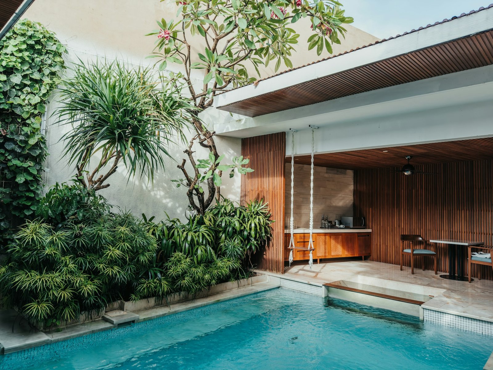Villa swimming pool surrounded by tropical landscaping