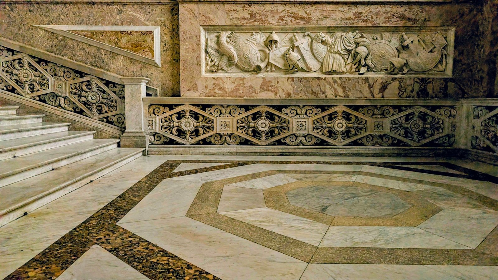 Inlaid marble flooring and stone staircase